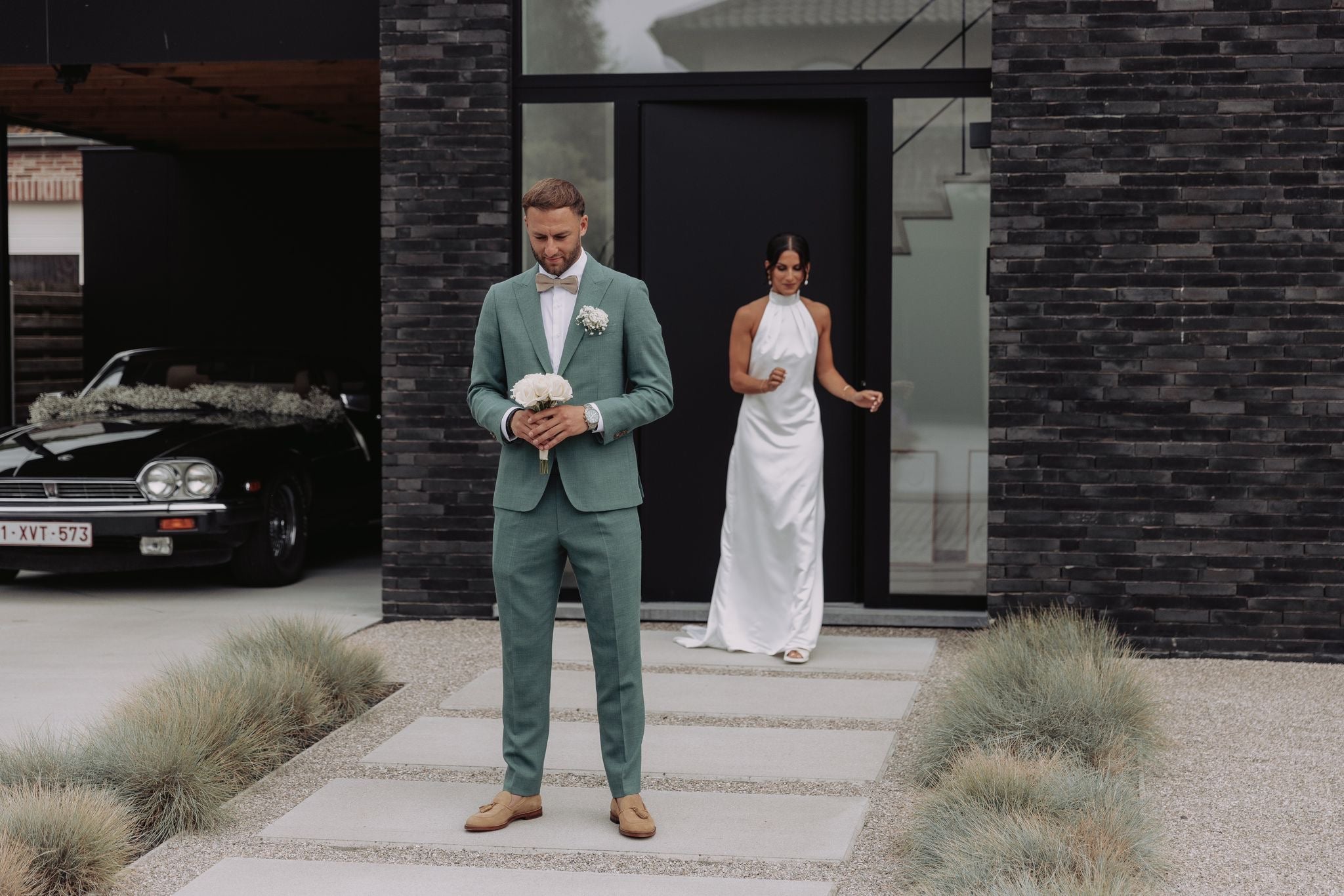 Newlywed couple celebrating, groom in a handcrafted Atelier ACÀN tuxedo.