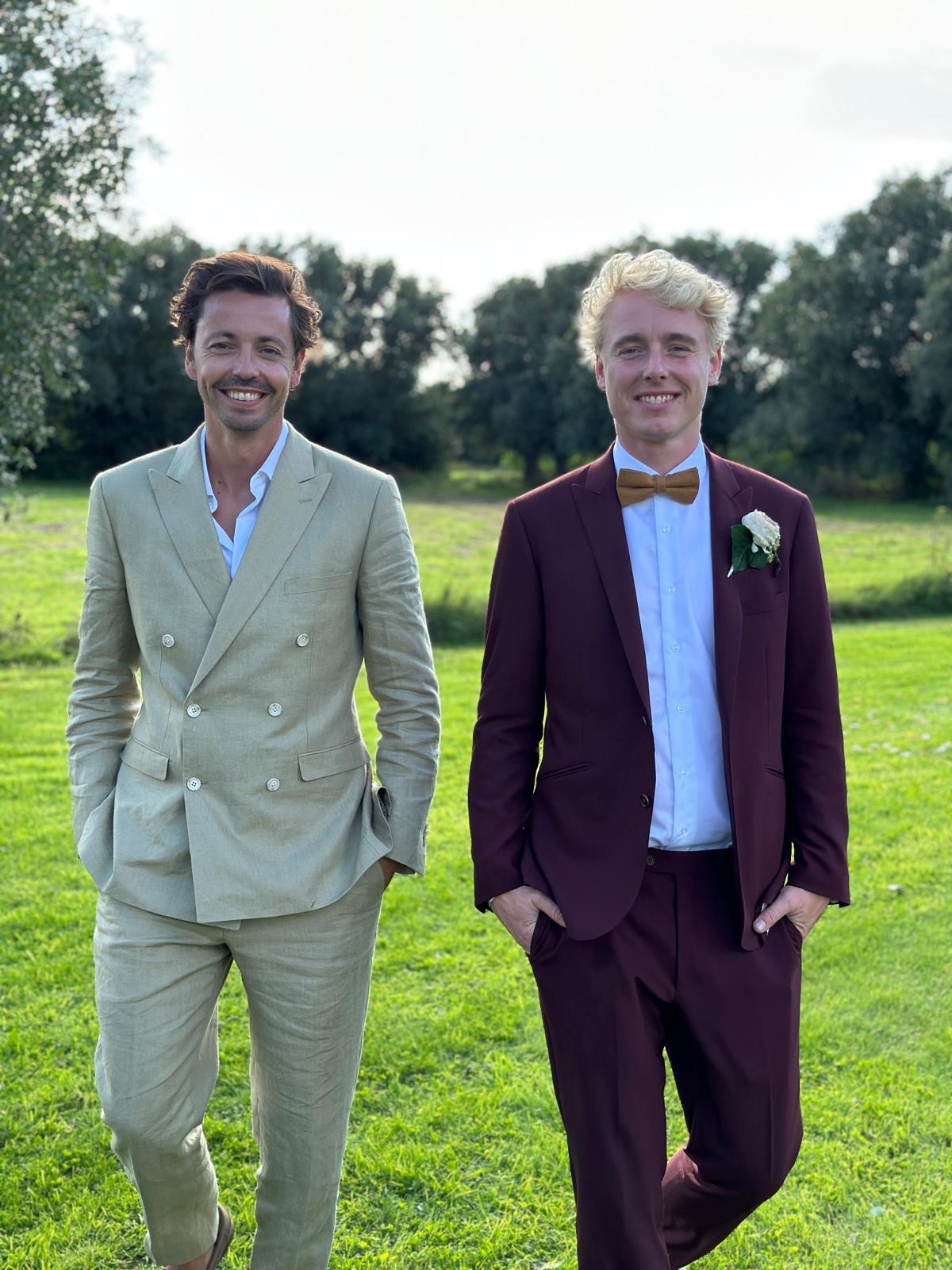 Newlywed couple celebrating, groom in a handcrafted Atelier ACÀN tuxedo.