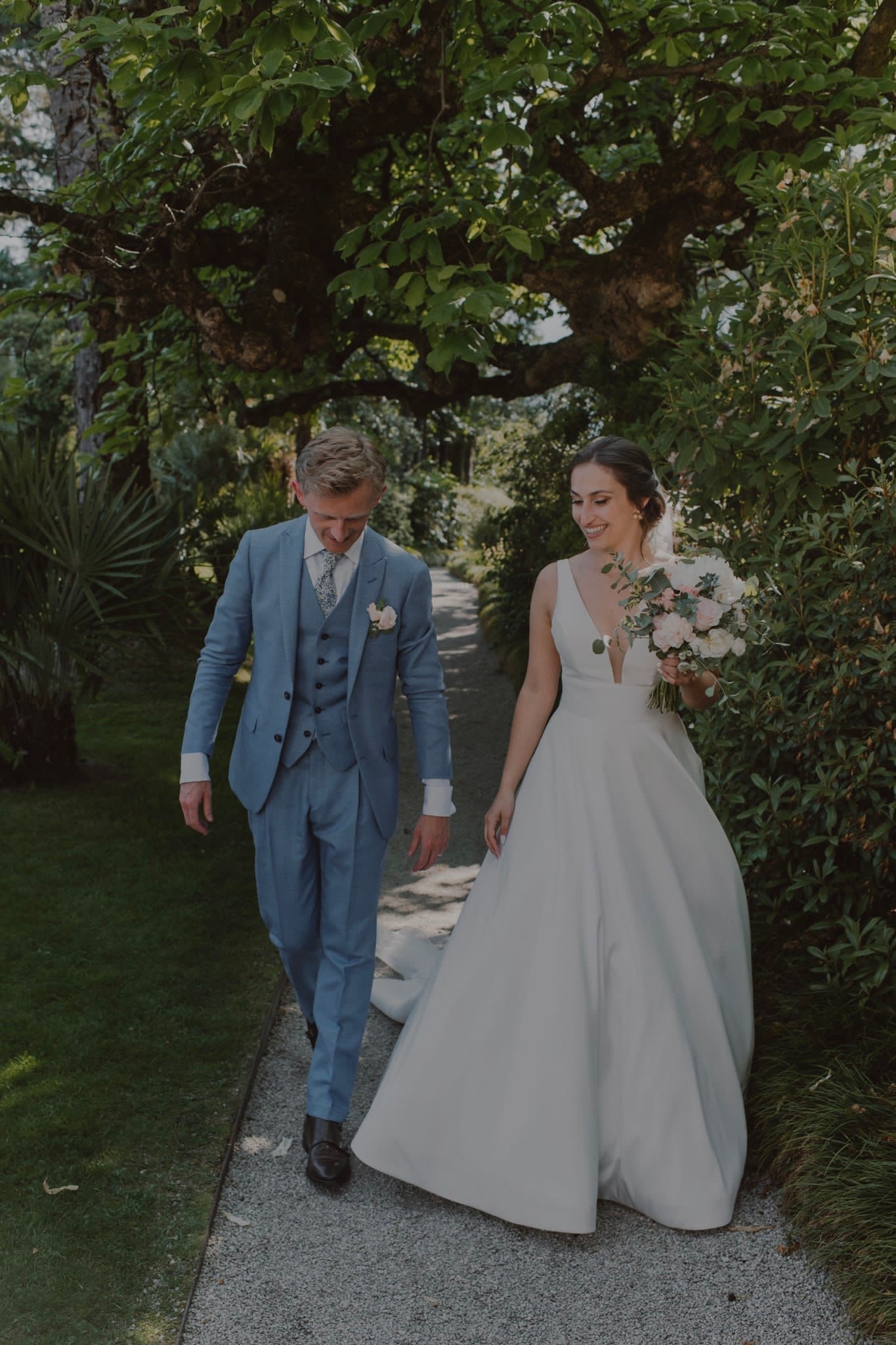Newlywed couple celebrating, groom in a handcrafted Atelier ACÀN tuxedo.