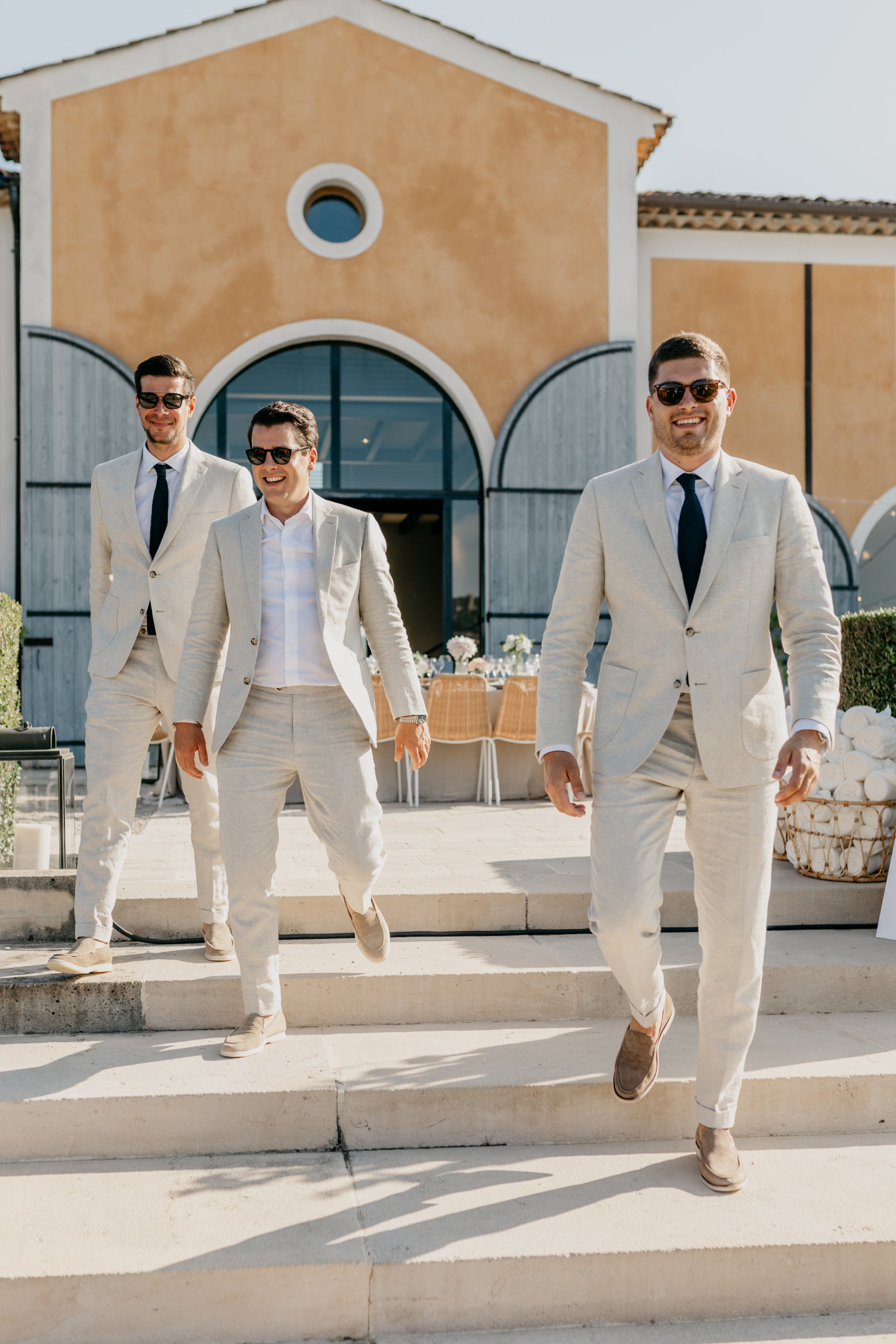 Best mans celebrating with the groom in a handcrafted Atelier ACÀN suit.
