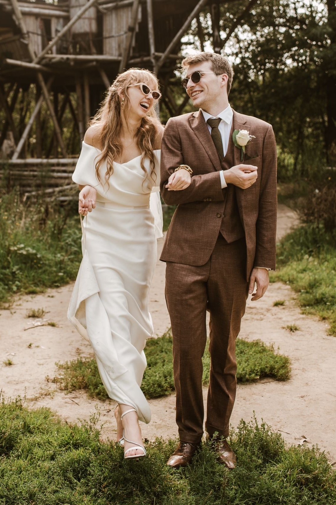 Newlywed couple celebrating, groom in a handcrafted Atelier ACÀN tuxedo.