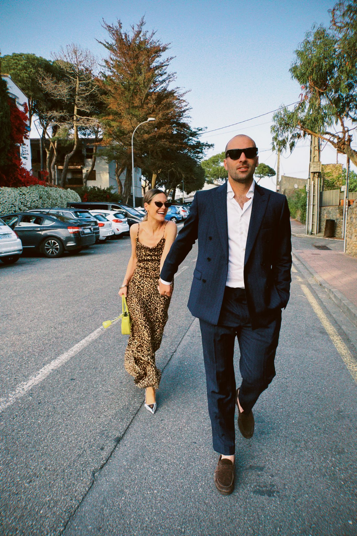Newlywed couple celebrating, groom in a handcrafted Atelier ACÀN tuxedo.