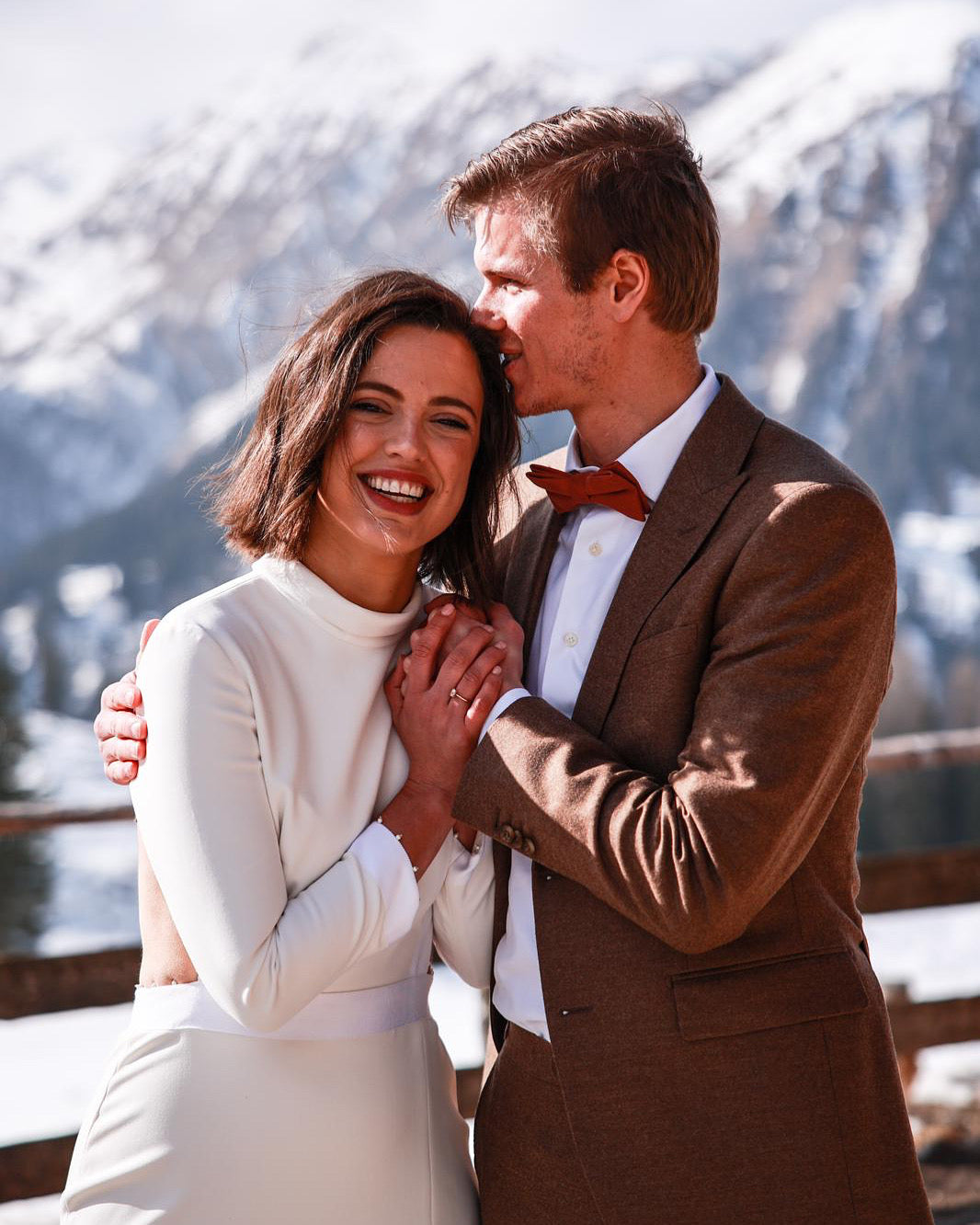 Newlywed couple celebrating, groom in a handcrafted Atelier ACÀN tuxedo.