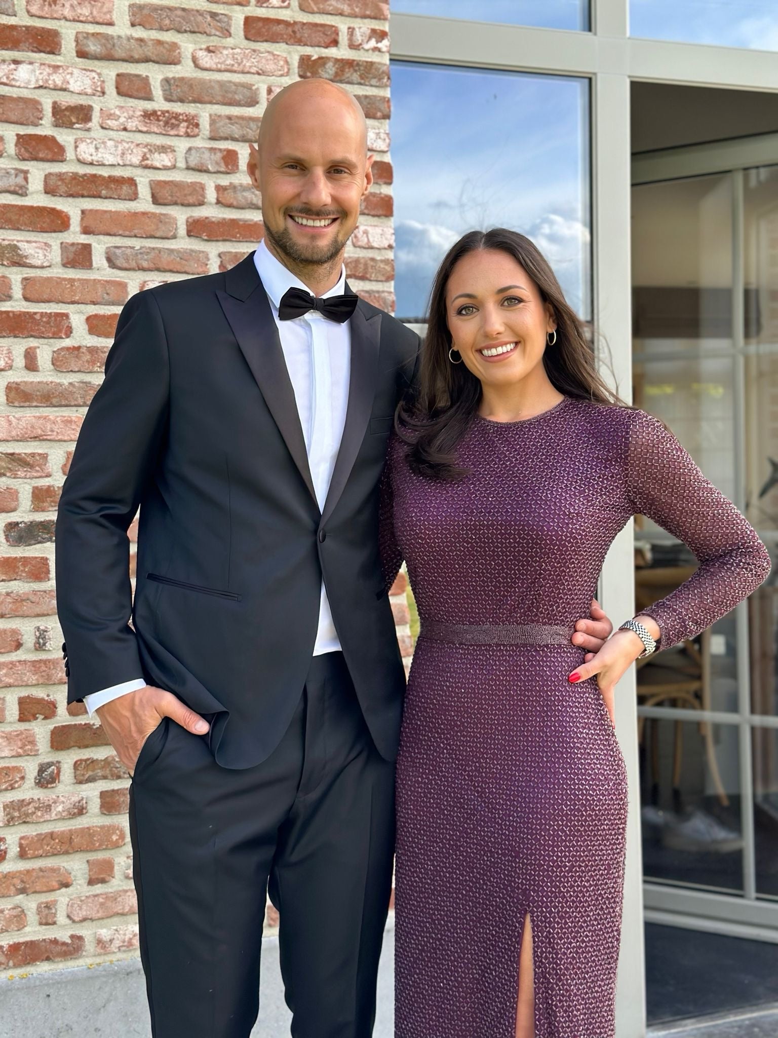 Newlywed couple celebrating, groom in a handcrafted Atelier ACÀN tuxedo.