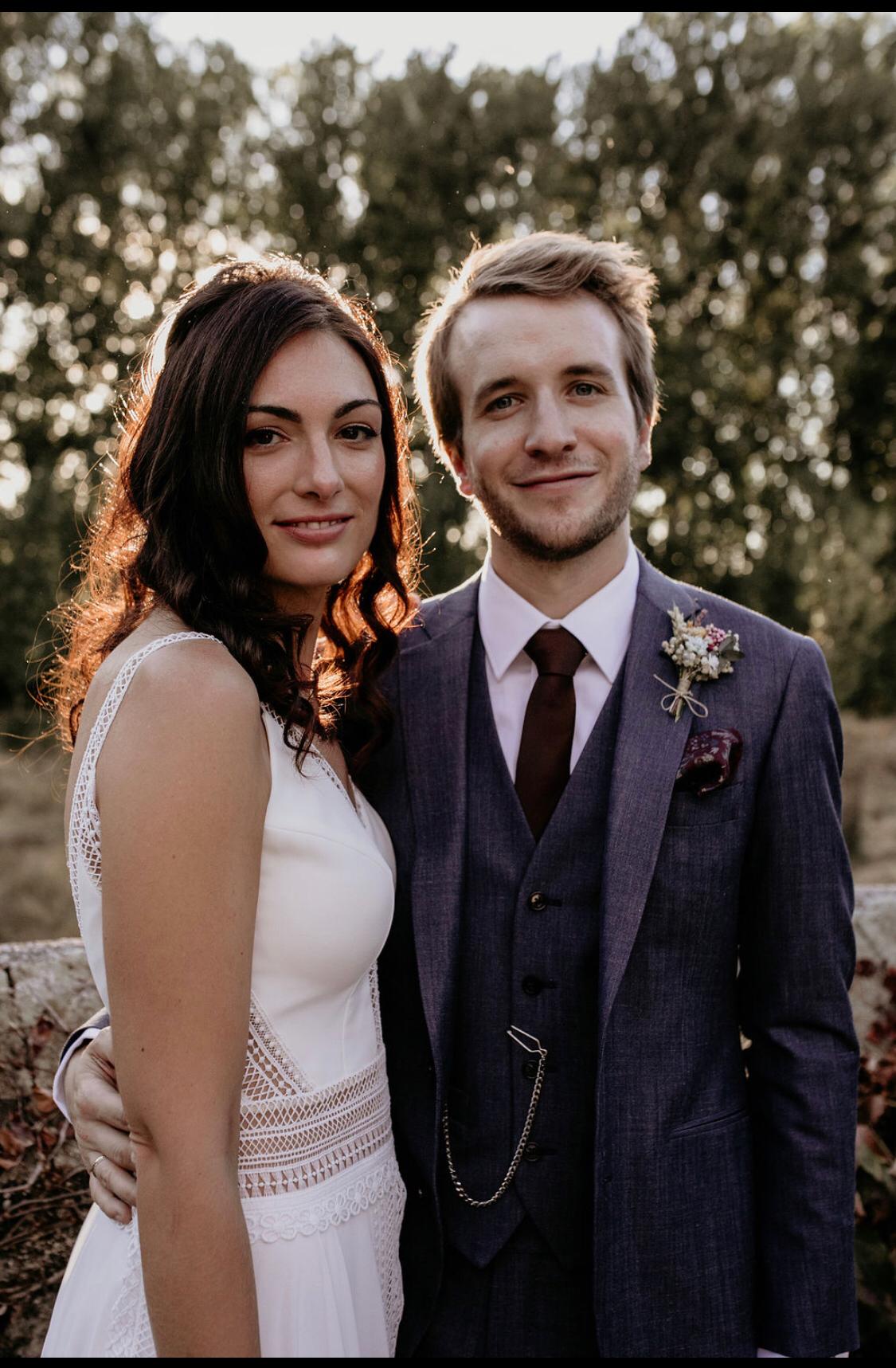 Newlywed couple celebrating, groom in a handcrafted Atelier ACÀN tuxedo.