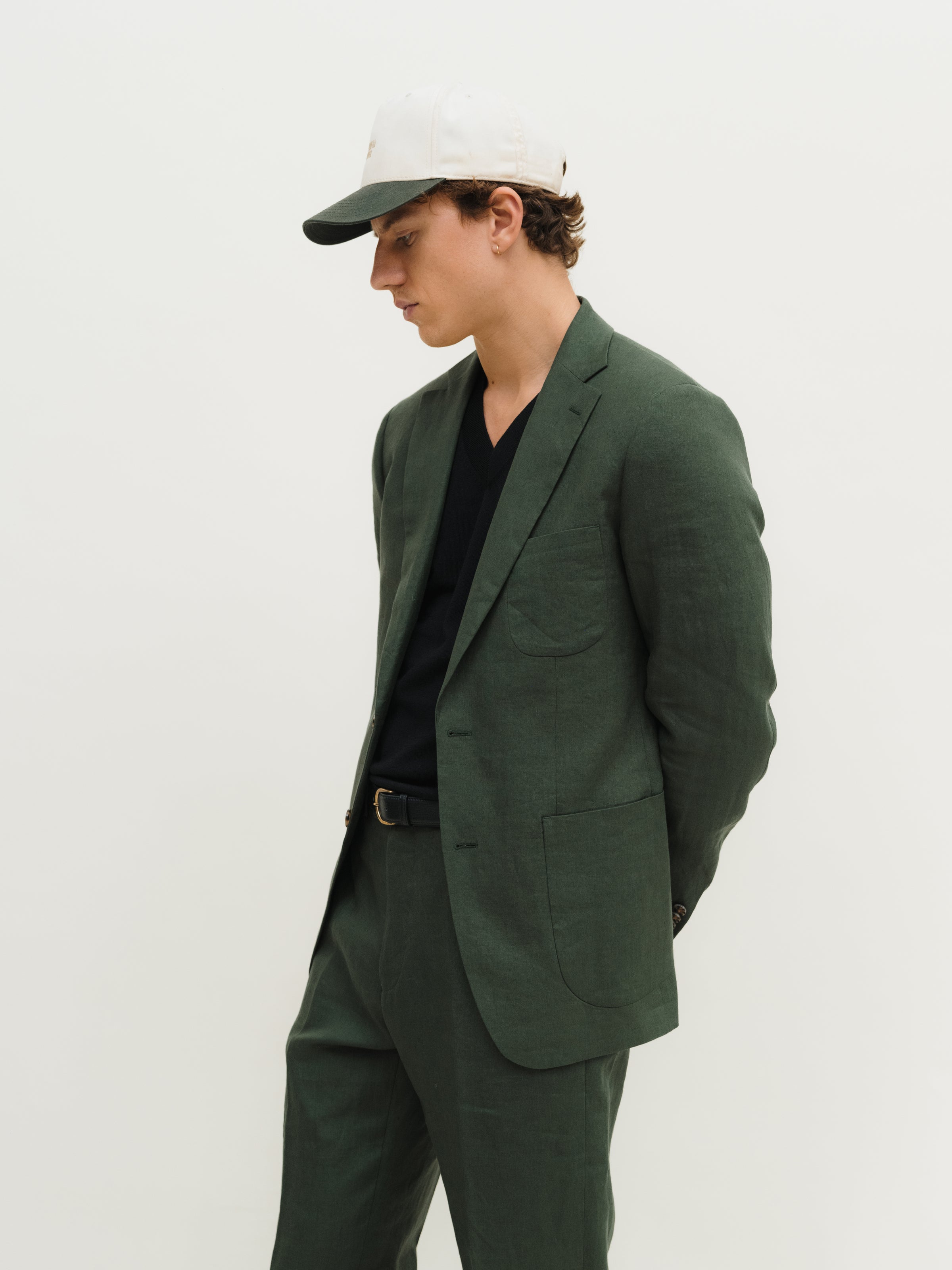 Bespoke suits in a variety of colors and styles, tailored by Atelier ACÀN in Antwerp and Ghent.