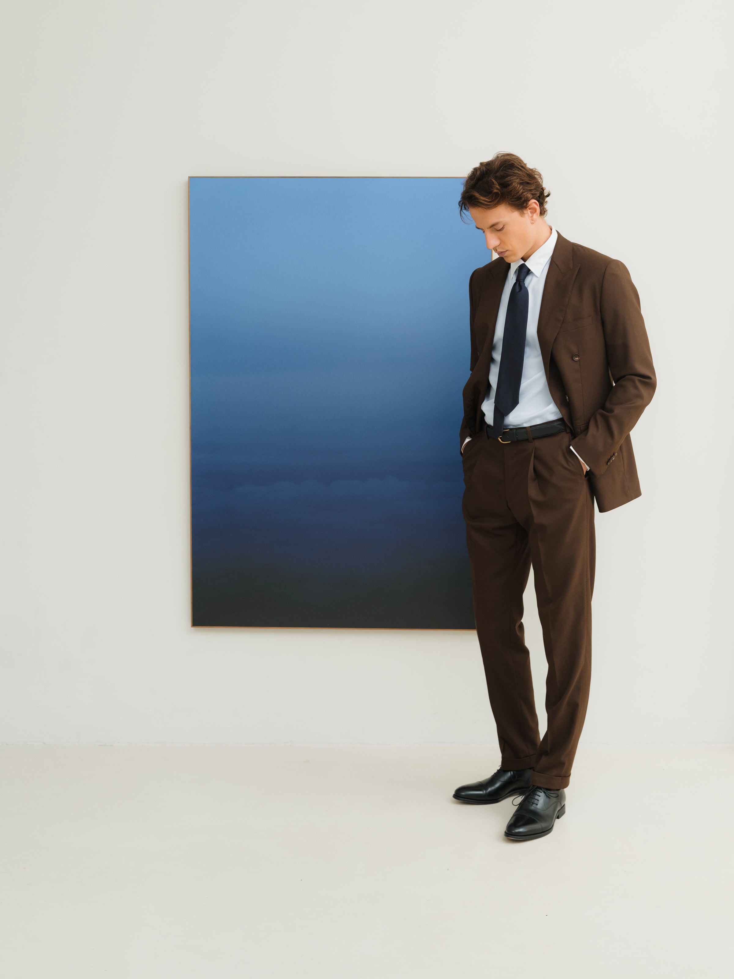 Dark brown tailored 2-piece suit for wedding and business occasions. And a navy tie to make it more elegant.