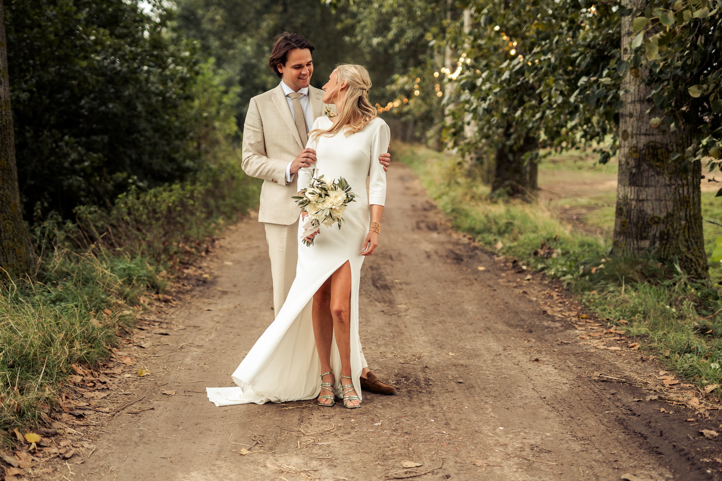 Newlywed couple celebrating, groom in a handcrafted Atelier ACÀN tuxedo.