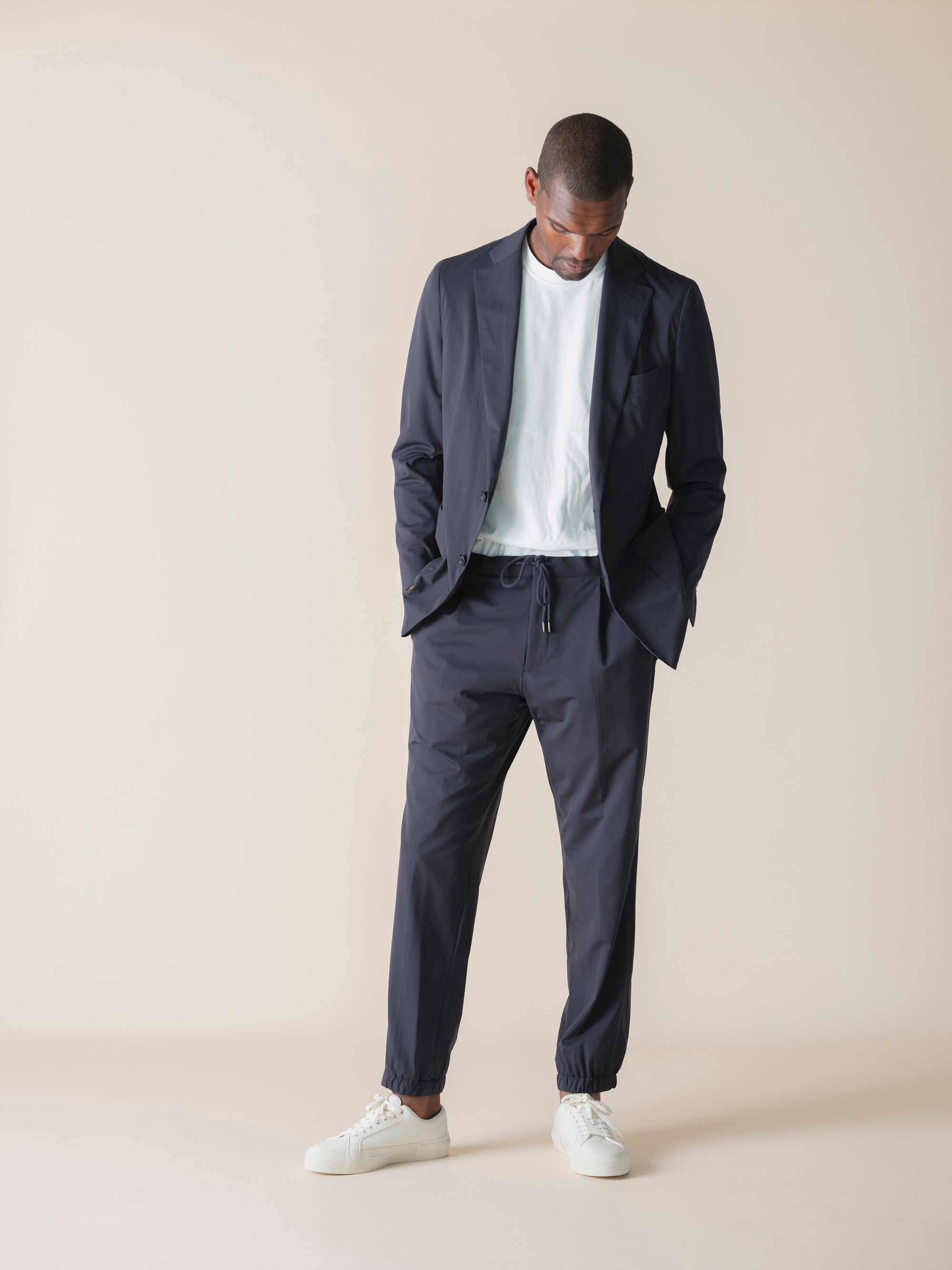 Custom-made suits in rich textures and shades, crafted with precision at Atelier ACÀN in Antwerp and Ghent.
