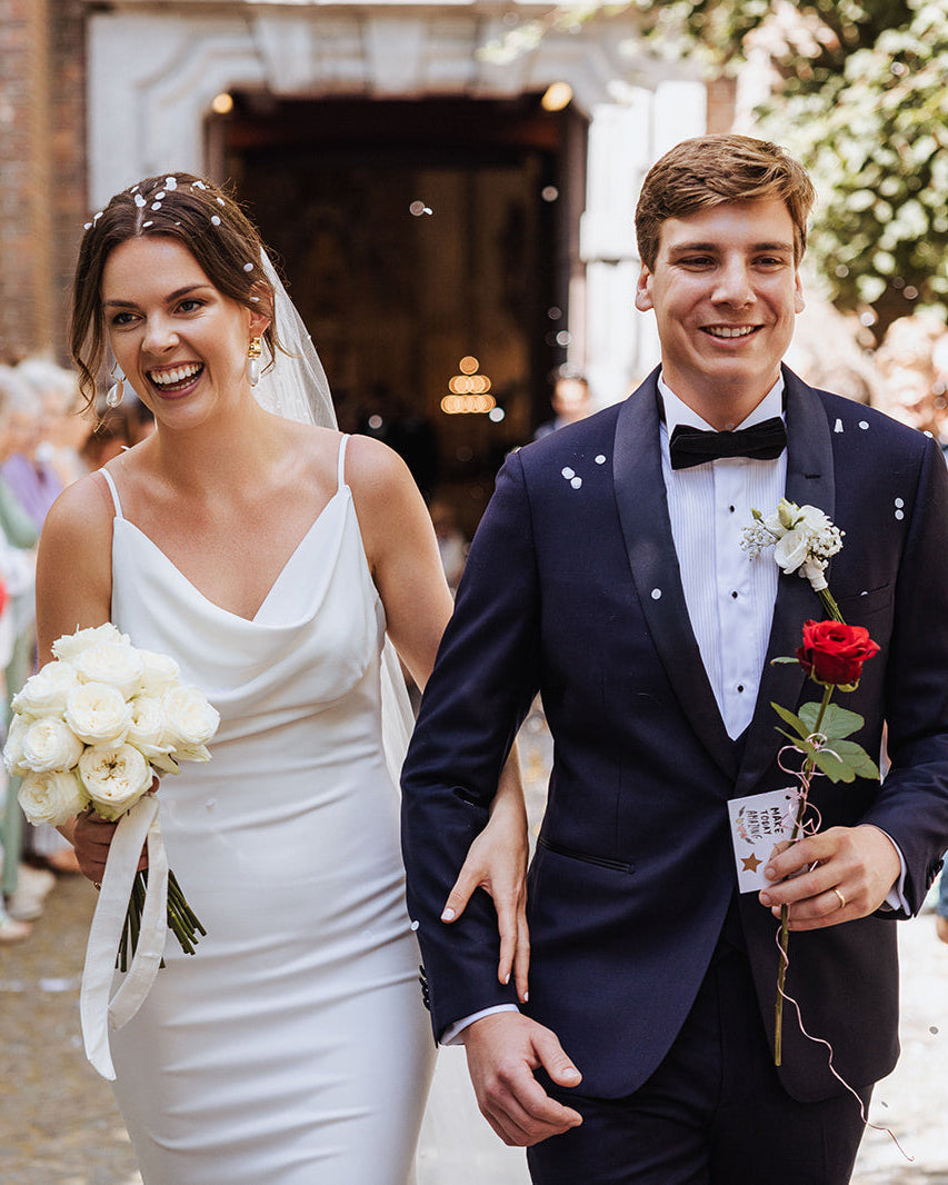 Groom in navy midnight blue tuxedo with black tie.