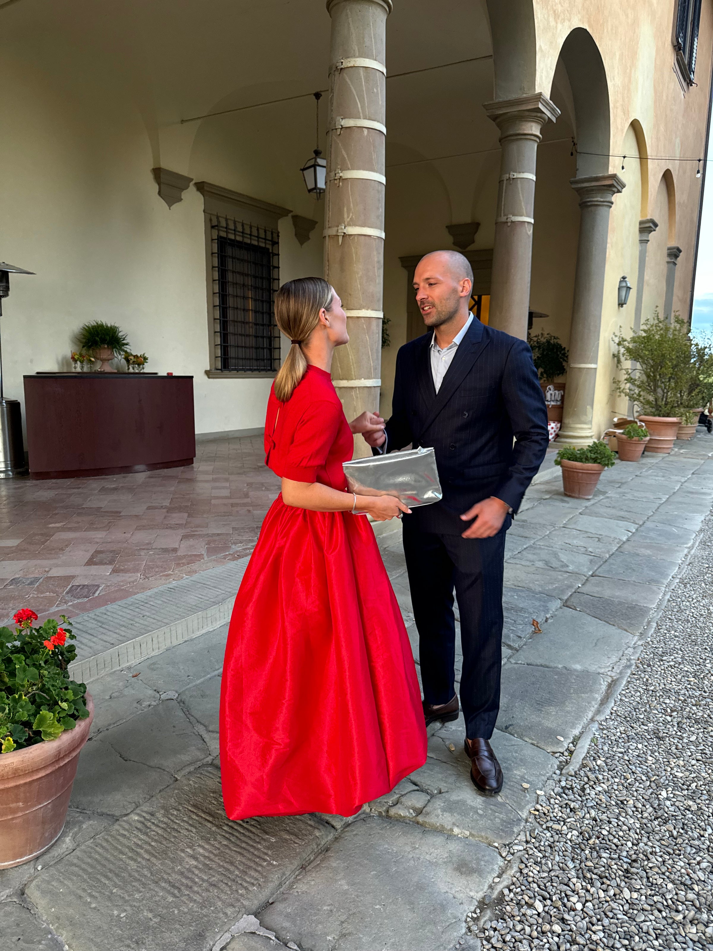 Newlywed couple celebrating, groom in a handcrafted Atelier ACÀN tuxedo.