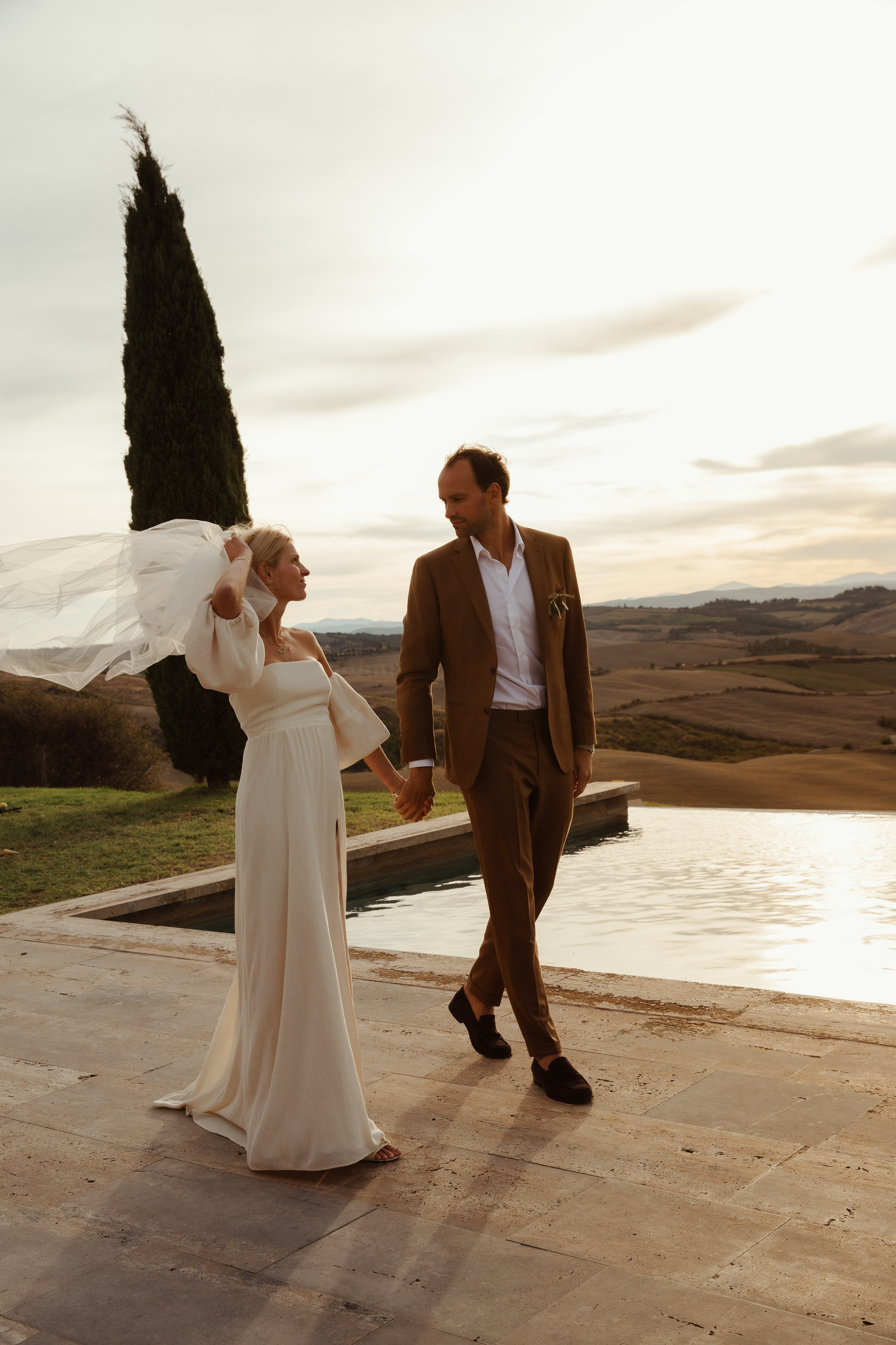 A couple posing lovely in south of Italy. The groom with his tobacco color suit.