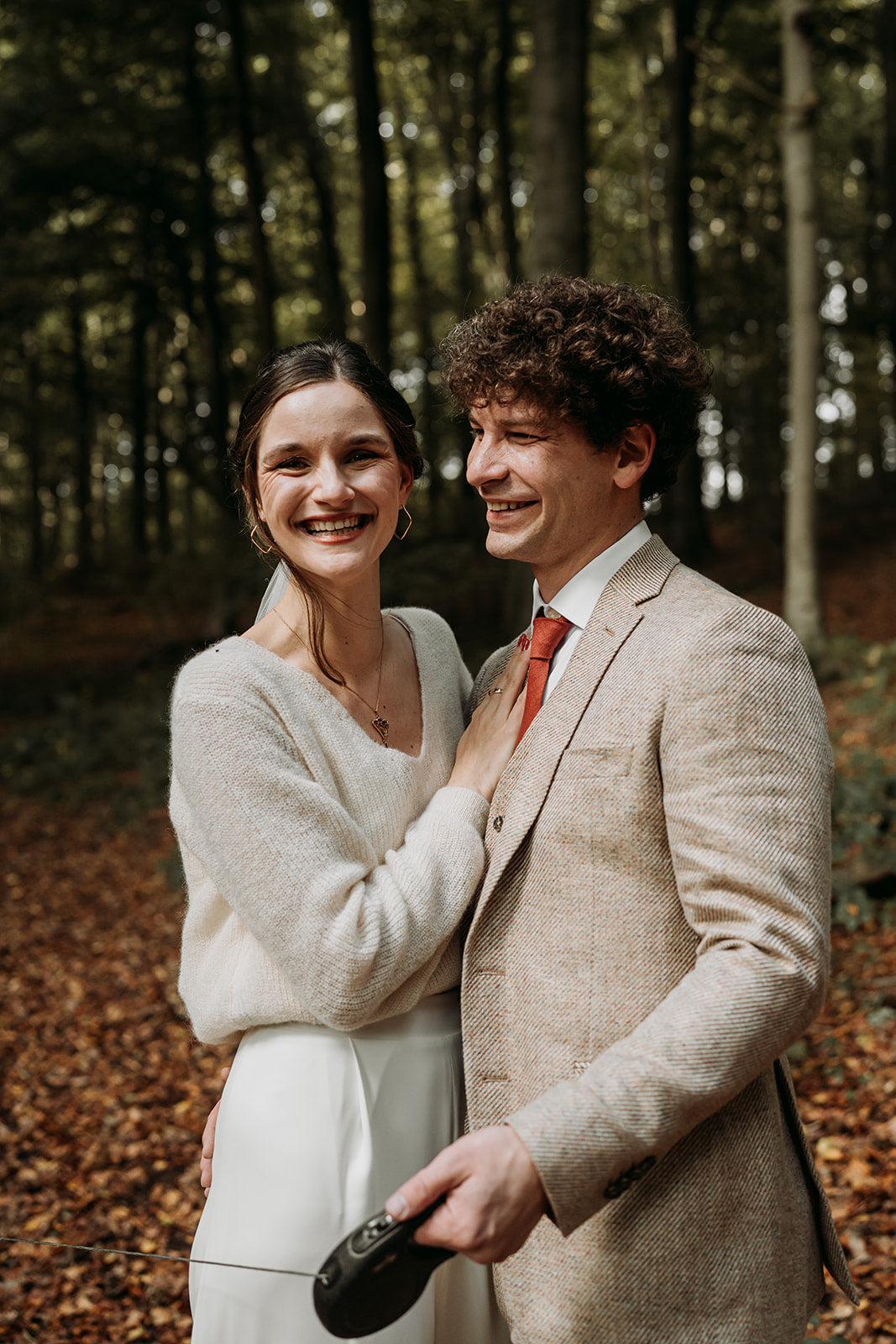Newlywed couple celebrating, groom in a handcrafted Atelier ACÀN tuxedo.