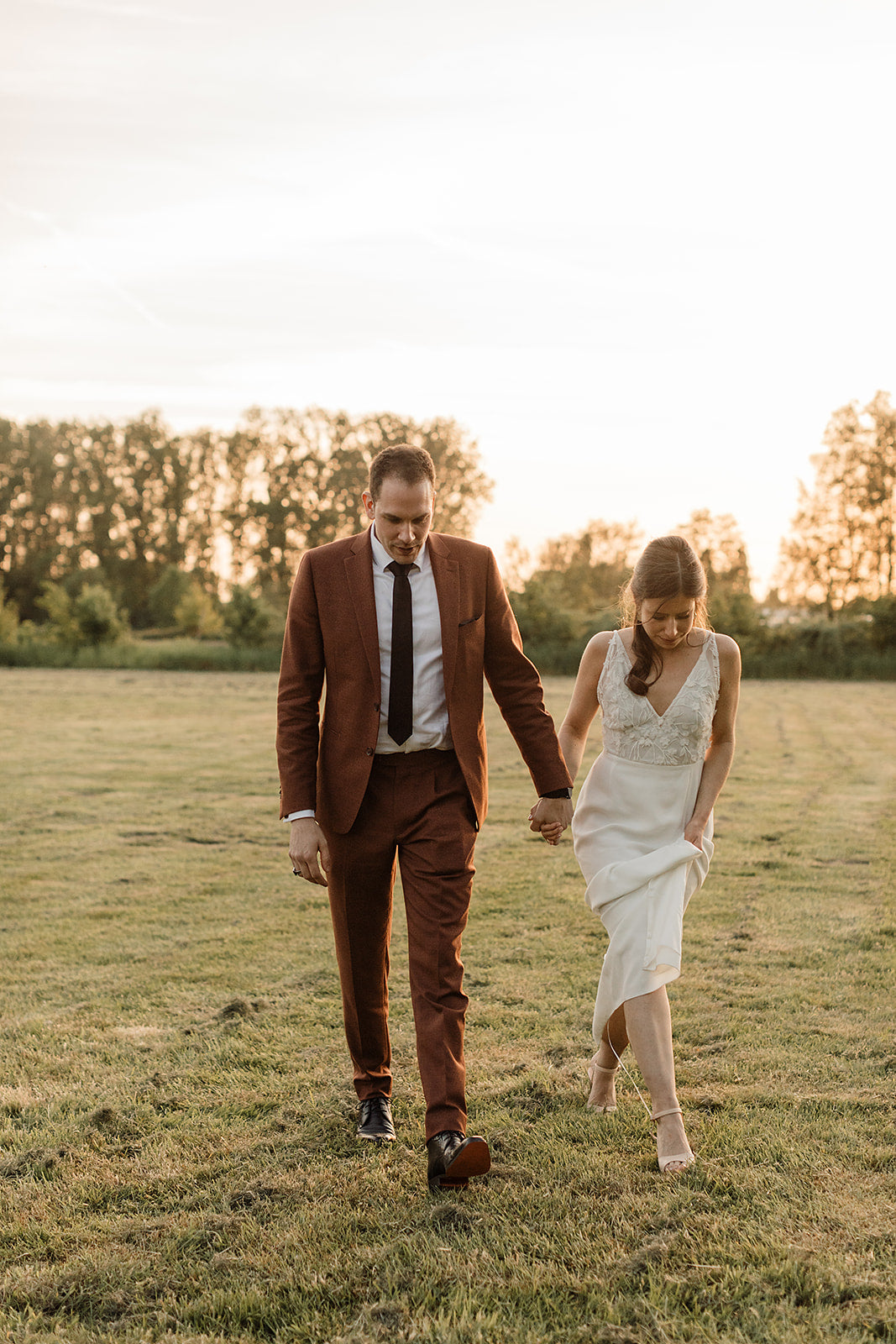 Newlywed couple celebrating, groom in a handcrafted Atelier ACÀN tuxedo.